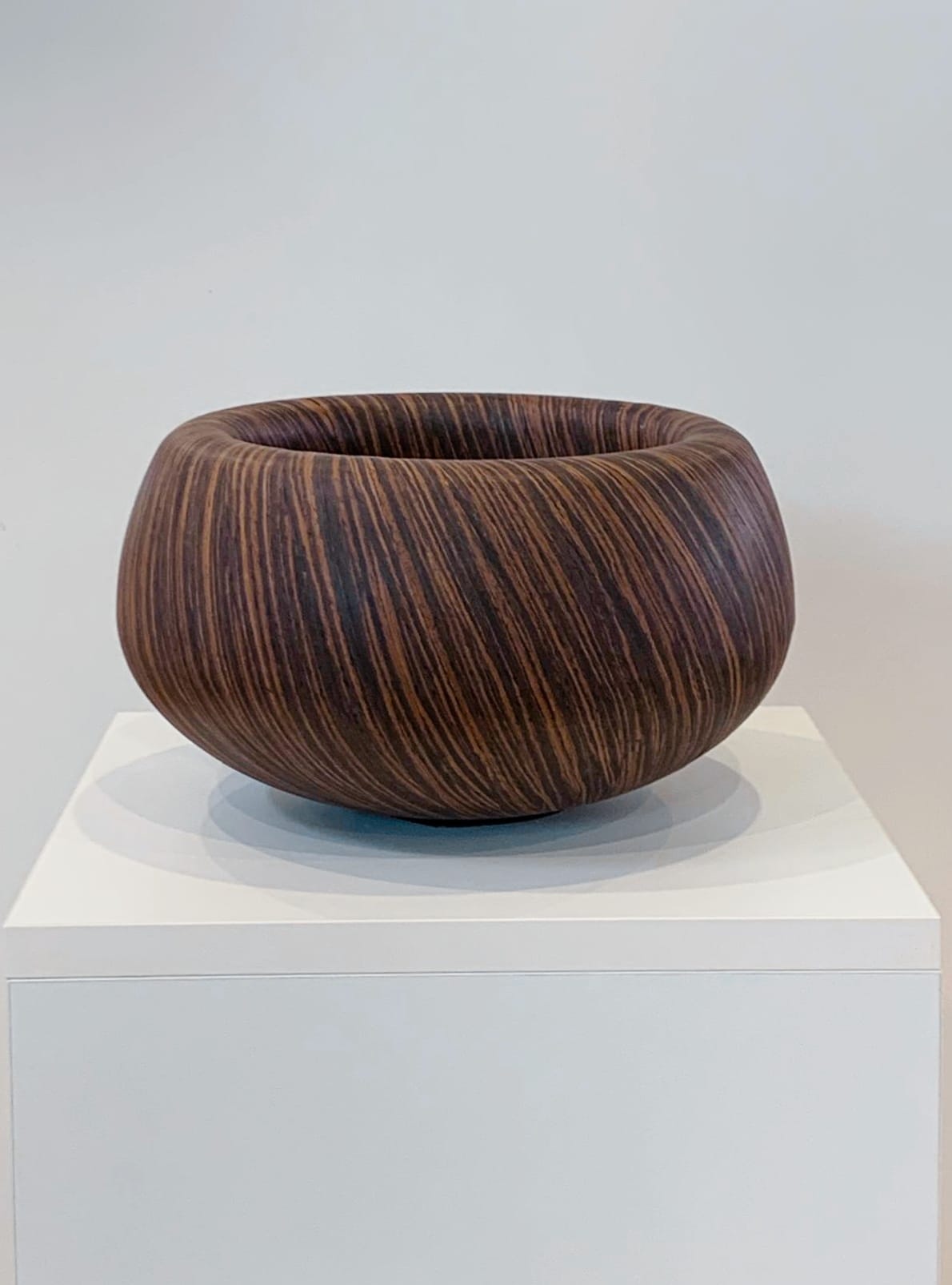 Reconstituted-ebony marquetry bowl on its plinth.